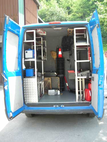 Photo of the interior of a mobile enforcement vehicle in Slovenia with doors open to show instruments used for checking the size and weight of commercial motor vehicles.