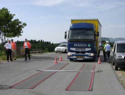 Photo of a commercial truck stopped at a mobile enforcement site in Slovenia.