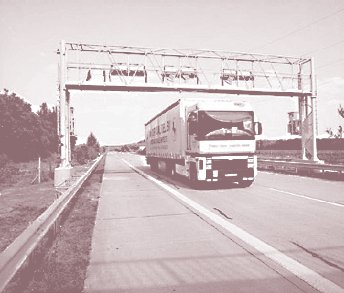 Photo of a commercial truck passing through an electronic toll system in Germany.