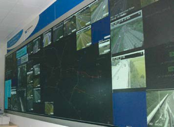 Photo of monitors on a wall at the West Midlands Traffic Control Center in Birmingham, England.
