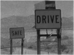 Front view of signs that say 'drive' and 'safe'
