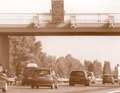 Photo of enforcement cameras and speed limit signage on A7 overpass.