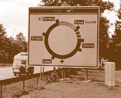 Photo of a variable message sign with congestion indication mounted next to a roadway.