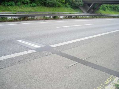 Photo of a stress-in-motion sensor installed in the roadway at the Eureka Logchain Footprint Project test site in Switzerland.