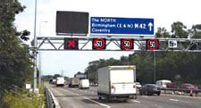 Photo of the M42 ATM without hard shoulder running and incident. Variable message sign over shoulder lane displays a red X, indicating the lane is not open to traffic. Signs over other lanes indicate a speed of 50.