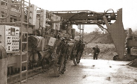 Photo showing dowel and tie bar inserters on back of front paver for two-lift paving in Austria.