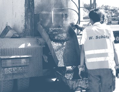 Photos of crew unloading a mastic asphalt transport.