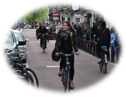 Picture beside Nieuwe Spiegelstraat (Amsterdam) - Description: Woman riding a bike in the street 