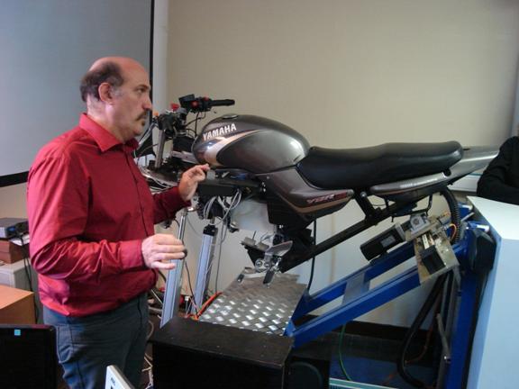 Figure 21. Photo of Stephane Espie of INRETS demonstrating a motorcycle simulator.