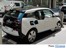 Curbside view of an electric vehicle plugged in at an on-street car-charging station. Photo: CCLicense