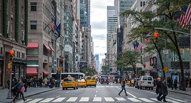 A large urban downtown from a street-level view. Source: Pexel