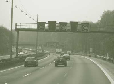 Variable signage seen over a six-lane highway.