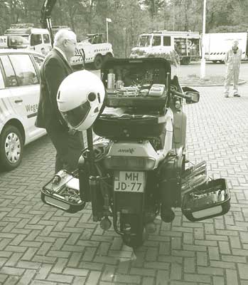 This photograph, titled "ANWB motorcycle," shows tool compartments on the back of a Dutch auto club motorcycle opened to reveal an assortment of small tools.