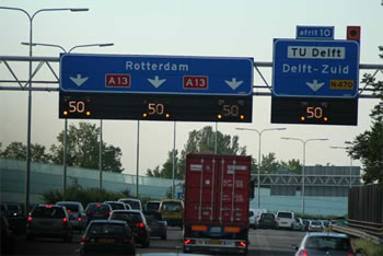 Photo of overhead motorway traffic management system showing speed limit.