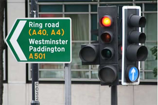 Photo of traffic light and road sign in London.