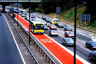 Photo of bus traveling in M4 bus lane and vehicles traveling in other two lanes of roadway.